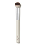 A close-up of the Complexion brush with a white handle and soft, dual-toned bristles.