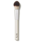A close-up of the Precision brush with a white handle and dense, dual-toned bristles.